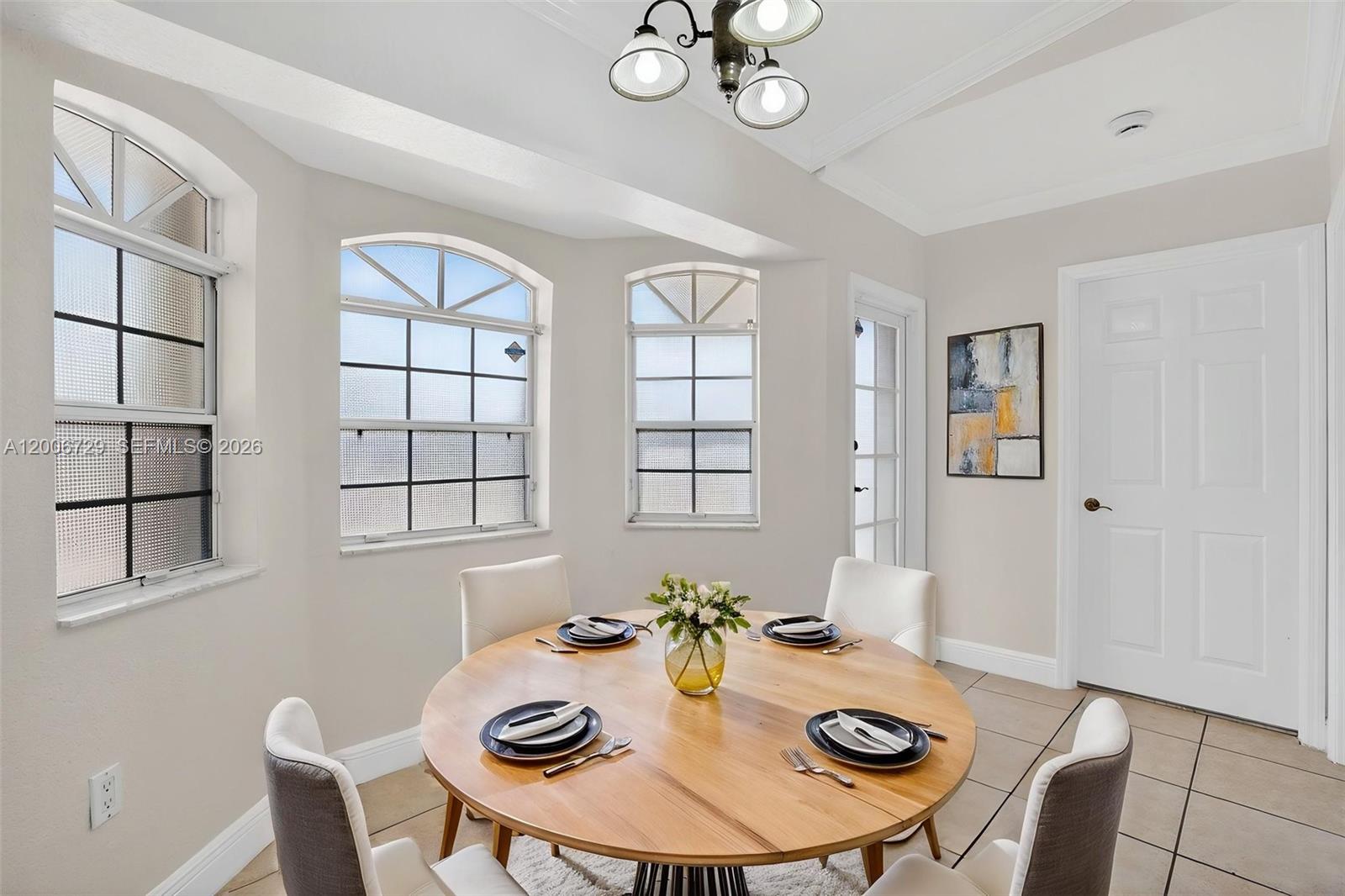 14251 Southwest 34th Street Miami, FL 33175 - Photo 19 of 54 a view of a dining room with furniture a chandelier and wooden floor
