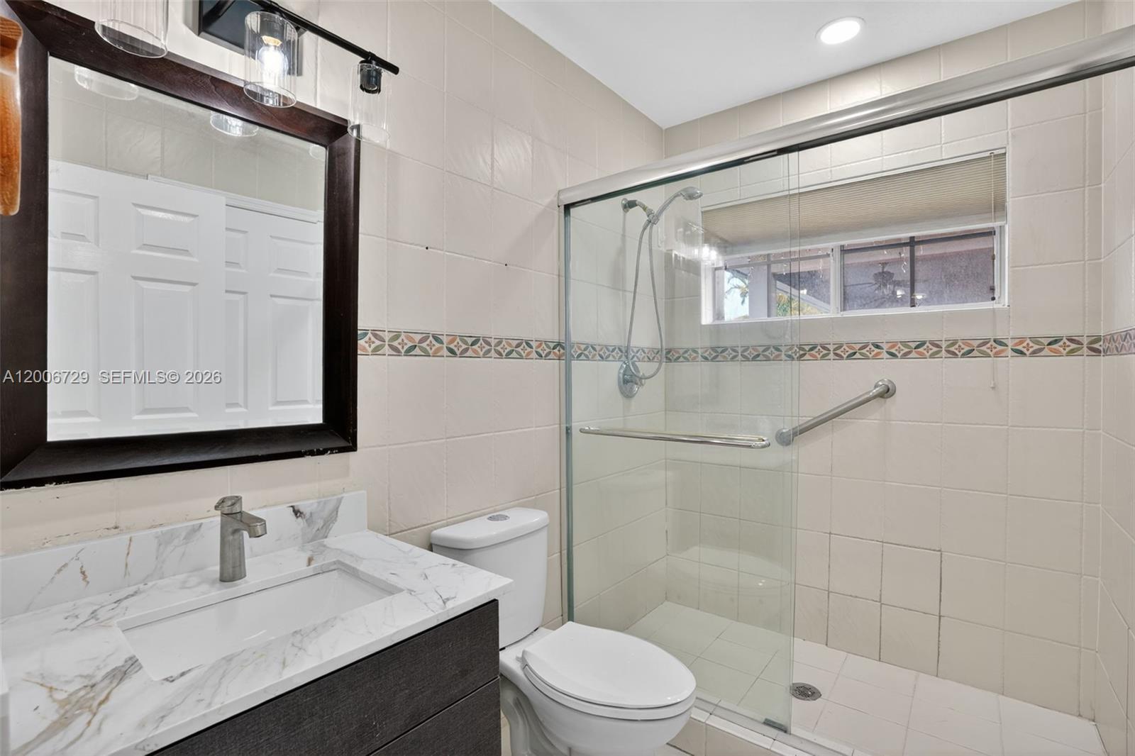 14251 Southwest 34th Street Miami, FL 33175 - Photo 22 of 54 a bathroom with a sink a toilet and shower