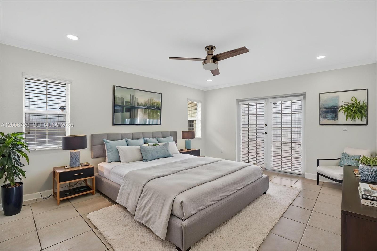 14251 Southwest 34th Street Miami, FL 33175 - Photo 25 of 54 a bedroom with a large bed and a chandelier