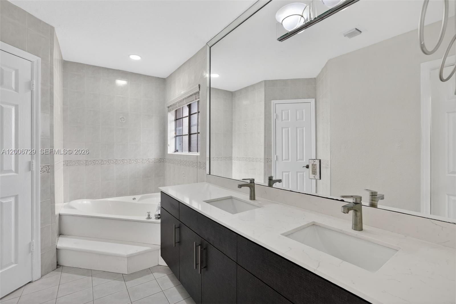 14251 Southwest 34th Street Miami, FL 33175 - Photo 28 of 54 a bathroom with a bathtub and a sink