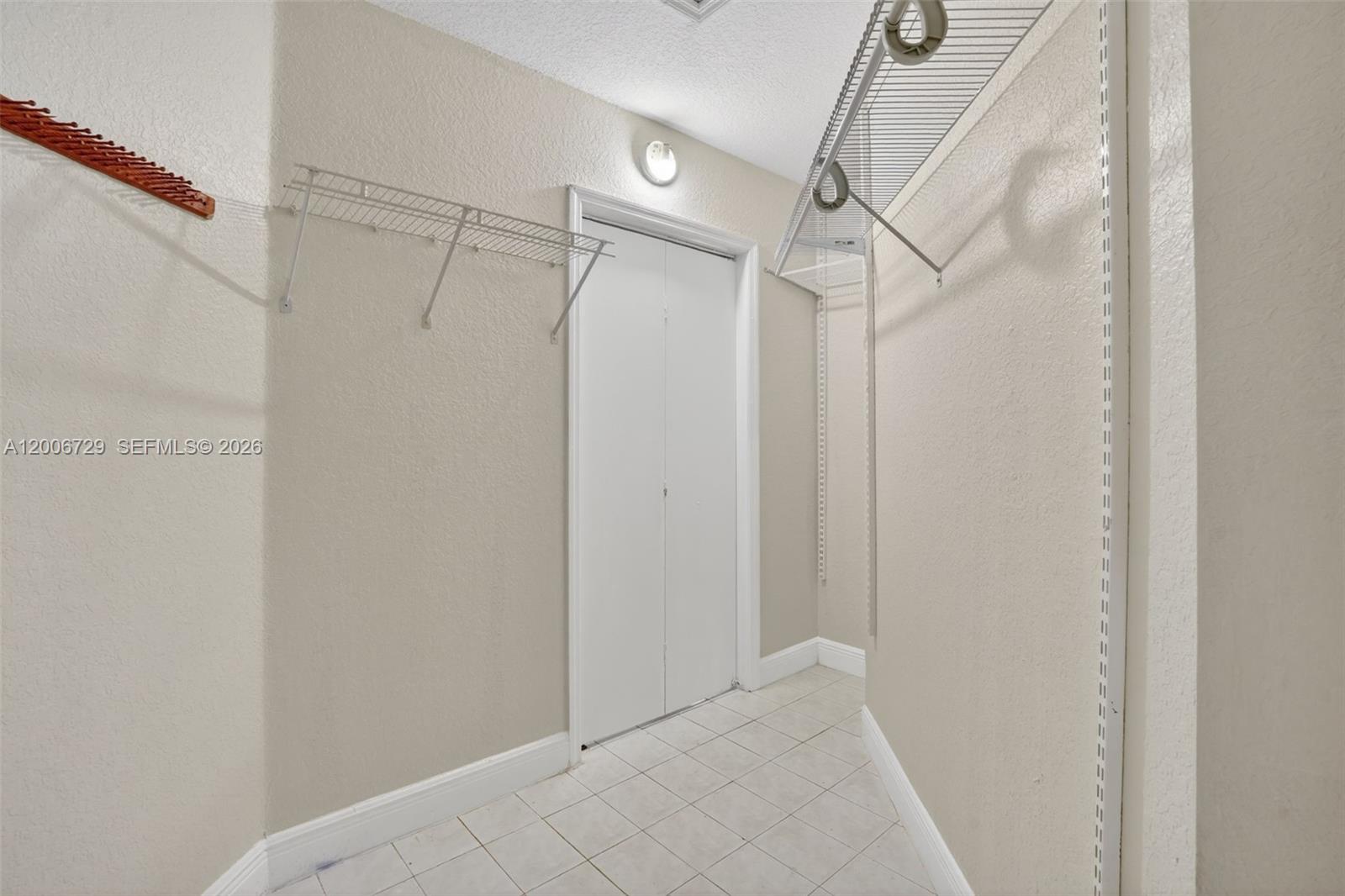 14251 Southwest 34th Street Miami, FL 33175 - Photo 31 of 54 a view of a room with racks on the wall