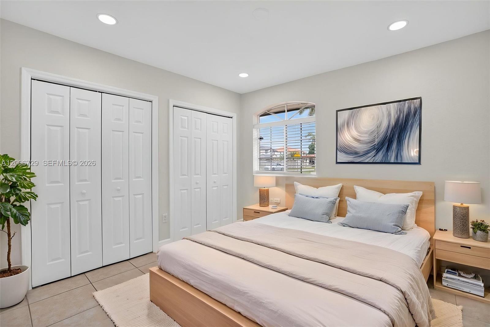 14251 Southwest 34th Street Miami, FL 33175 - Photo 33 of 54 a bedroom with a large bed and a potted plant