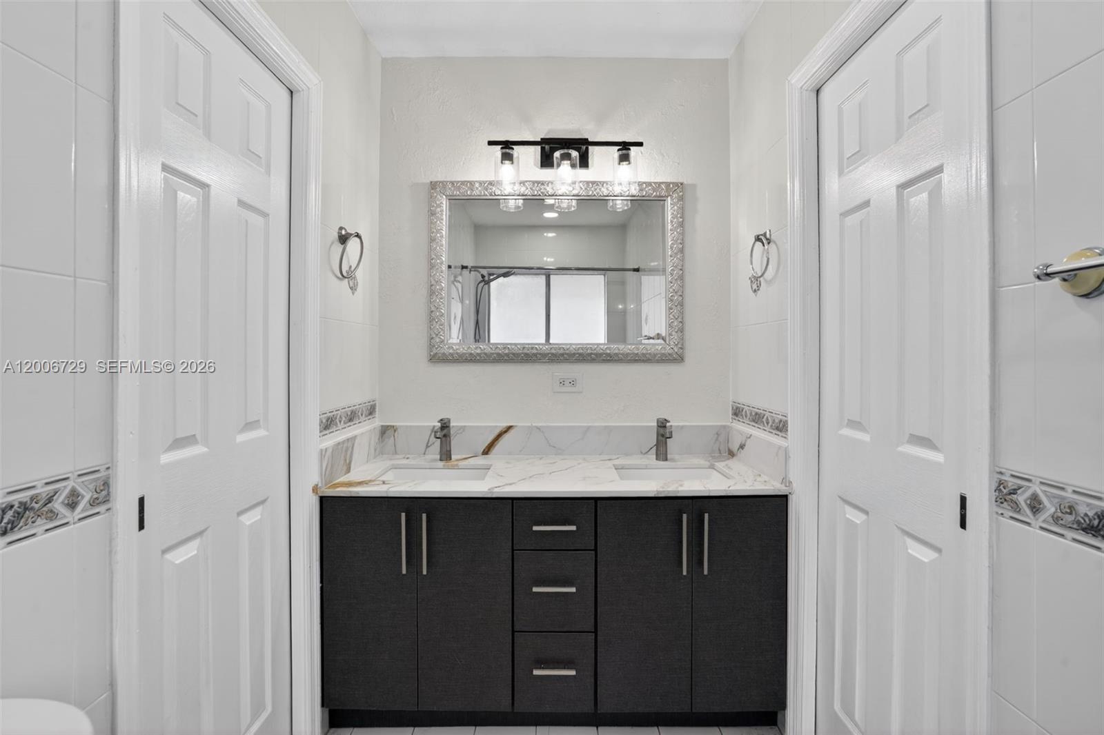 14251 Southwest 34th Street Miami, FL 33175 - Photo 35 of 54 a bathroom with a double vanity sink mirror and