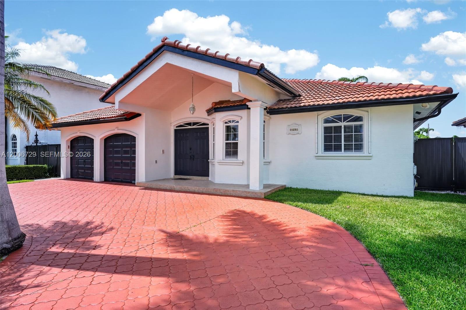 14251 Southwest 34th Street Miami, FL 33175 - Photo 4 of 54 a front view of a house with a yard and garage