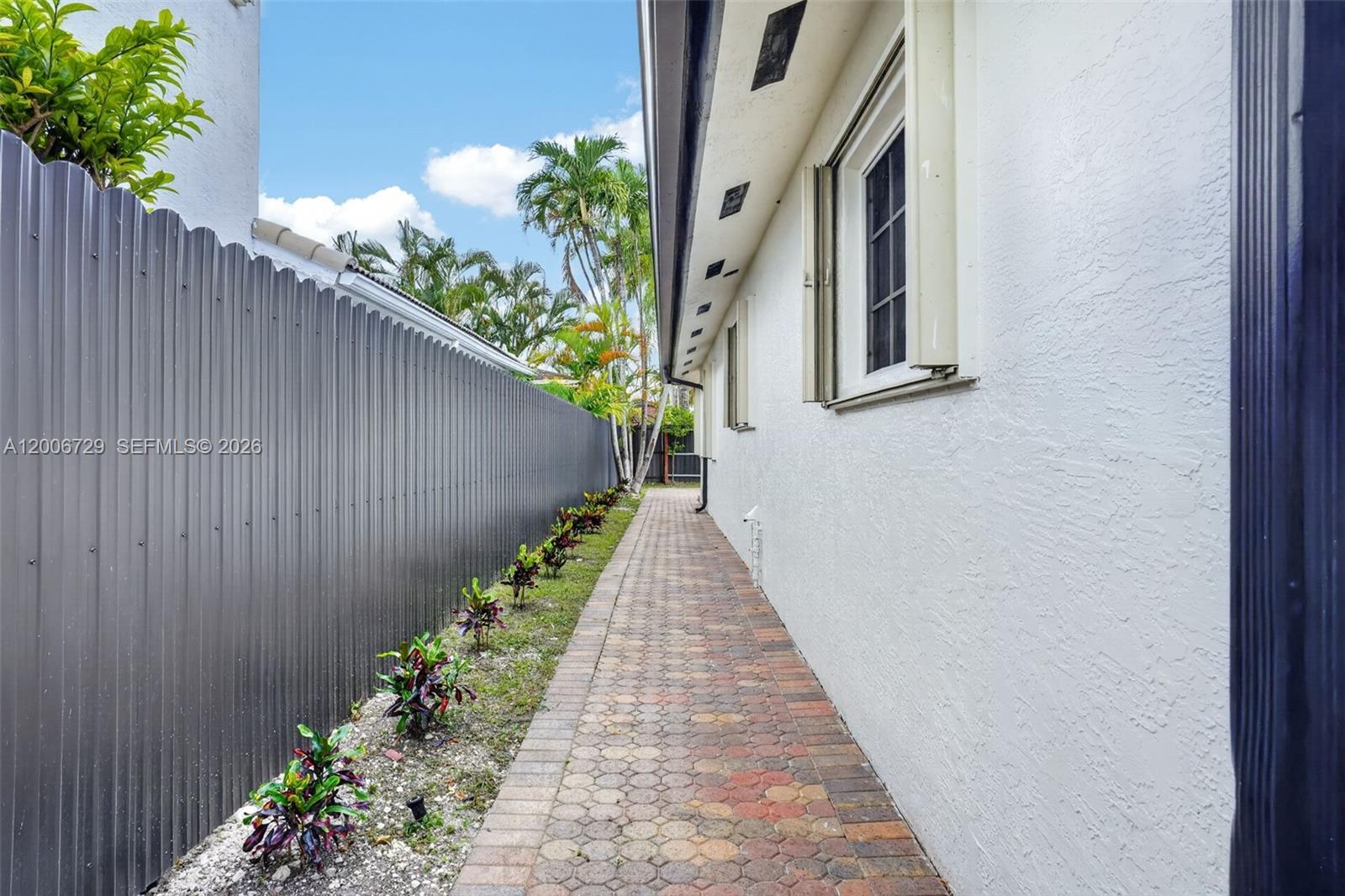 14251 Southwest 34th Street Miami, FL 33175 - Photo 43 of 54 a view of a pathway with a flower in a corridor