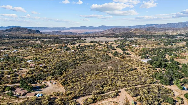 a view of a chair and table in the backyard