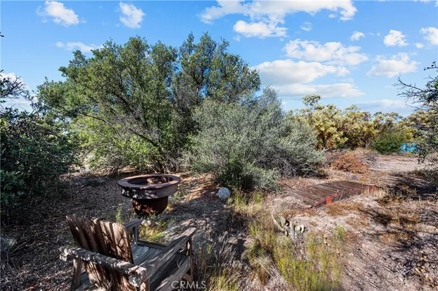 a view of a lounge chair in the backyard of a house