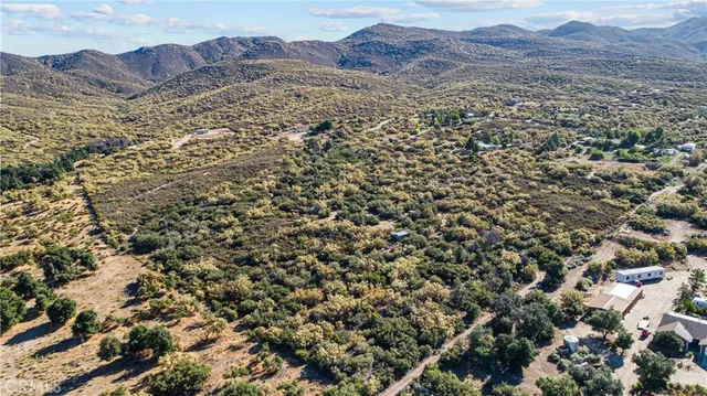 an aerial view of residential house and sandy dunes