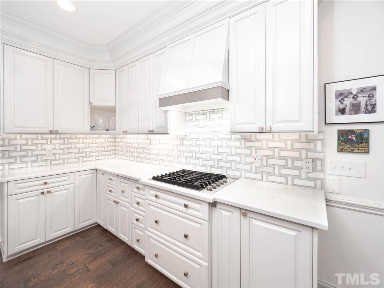 3521 Barron Berkeley Way Raleigh, NC 27612 - Photo 15 of 30 a kitchen with granite countertop white cabinets and white appliances