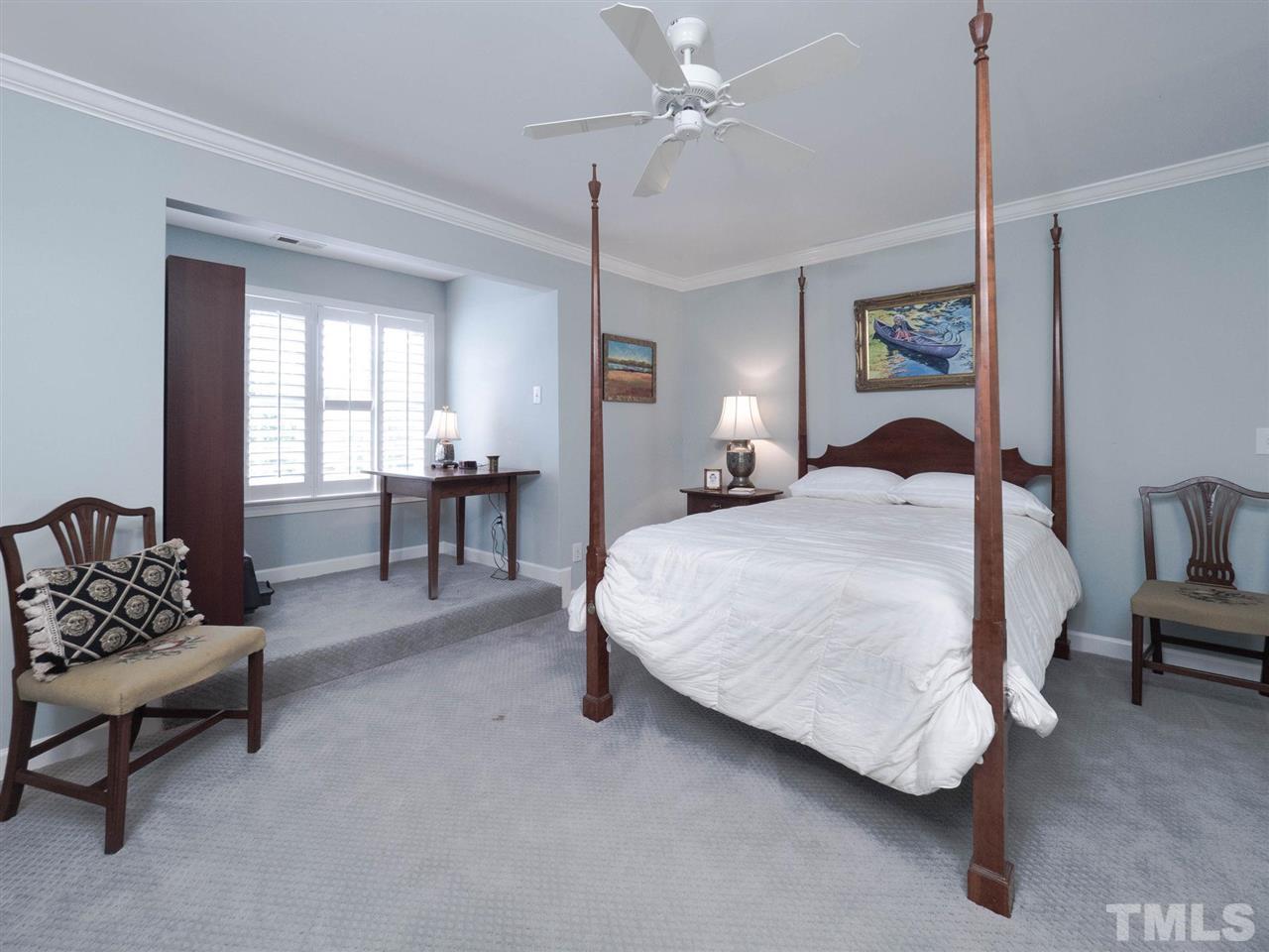 3521 Barron Berkeley Way Raleigh, NC 27612 - Photo 23 of 30 a bedroom with a bed furniture chandelier and a window