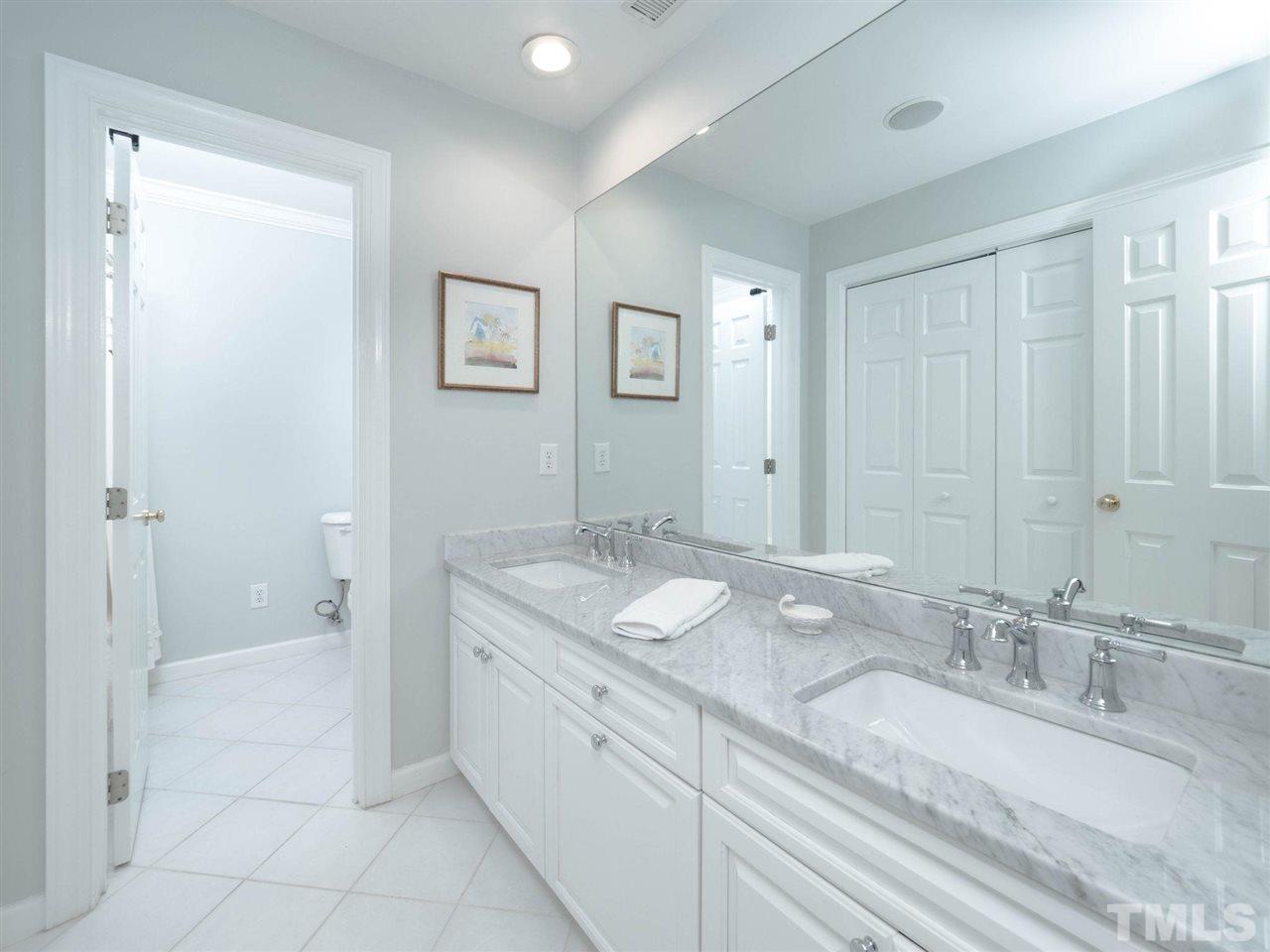 3521 Barron Berkeley Way Raleigh, NC 27612 - Photo 24 of 30 a bathroom with a granite countertop sink and a mirror