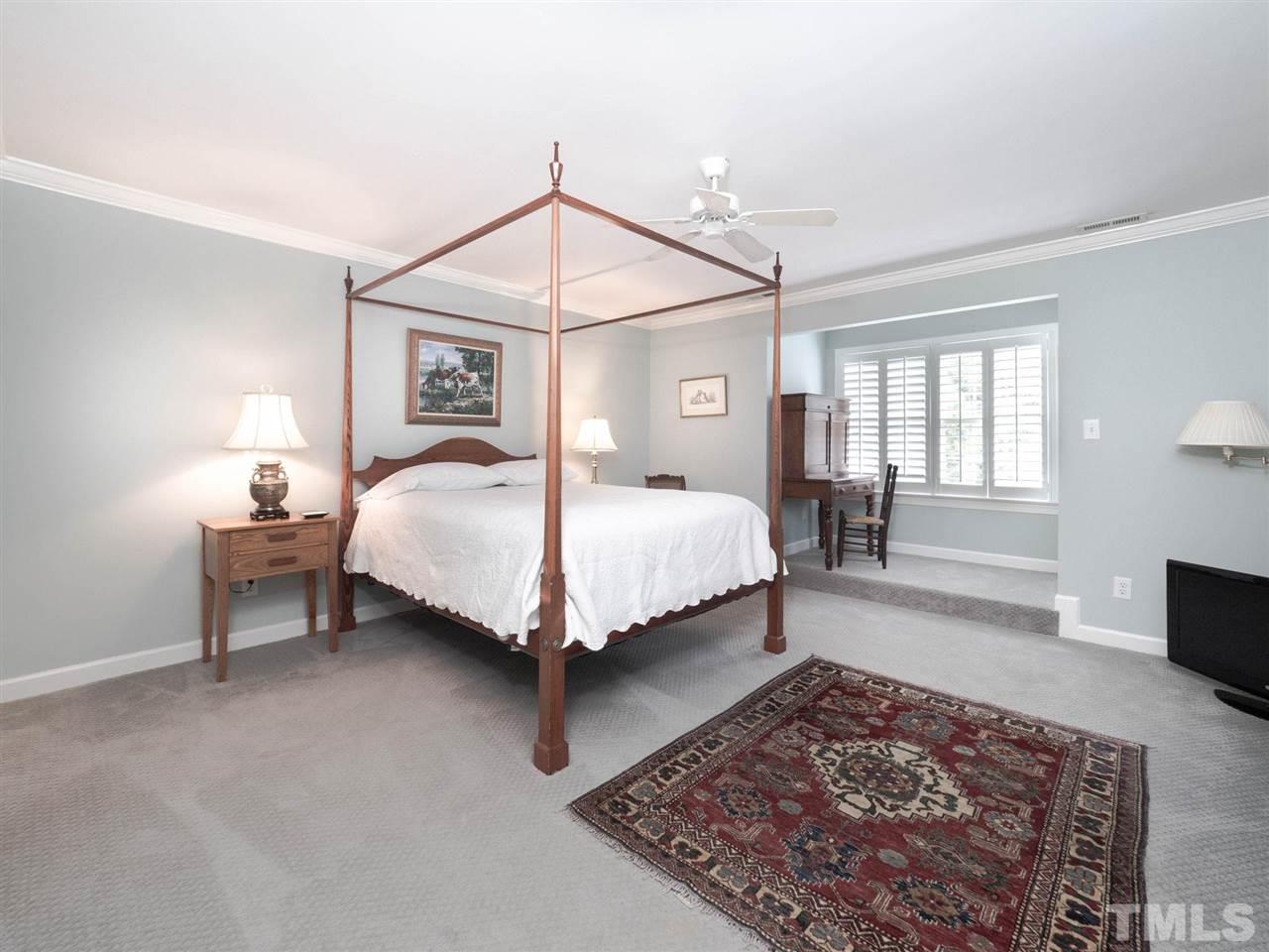 3521 Barron Berkeley Way Raleigh, NC 27612 - Photo 25 of 30 a bedroom with a bed and a couch