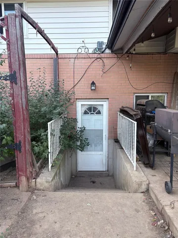 a view of a porch with furniture and floor to ceiling window
