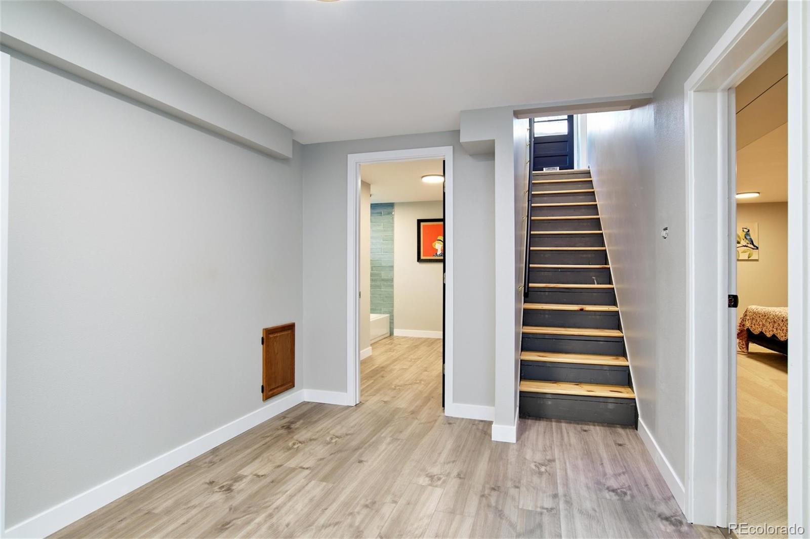 3225 Vance Street Wheat Ridge, CO 80033 - Photo 15 of 29 a view of a hallway with wooden floor and staircase