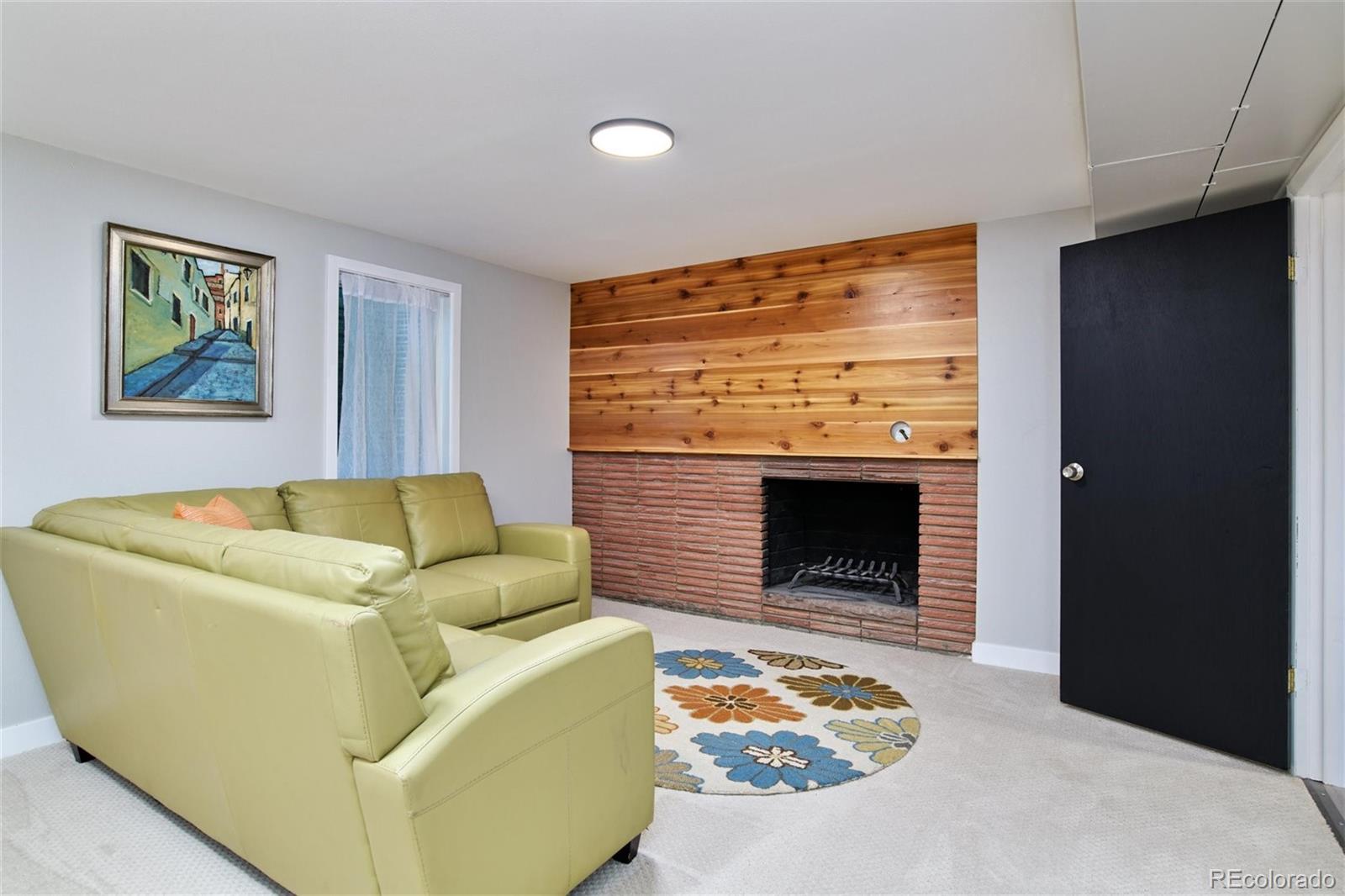 3225 Vance Street Wheat Ridge, CO 80033 - Photo 17 of 29 a living room with furniture and a fireplace