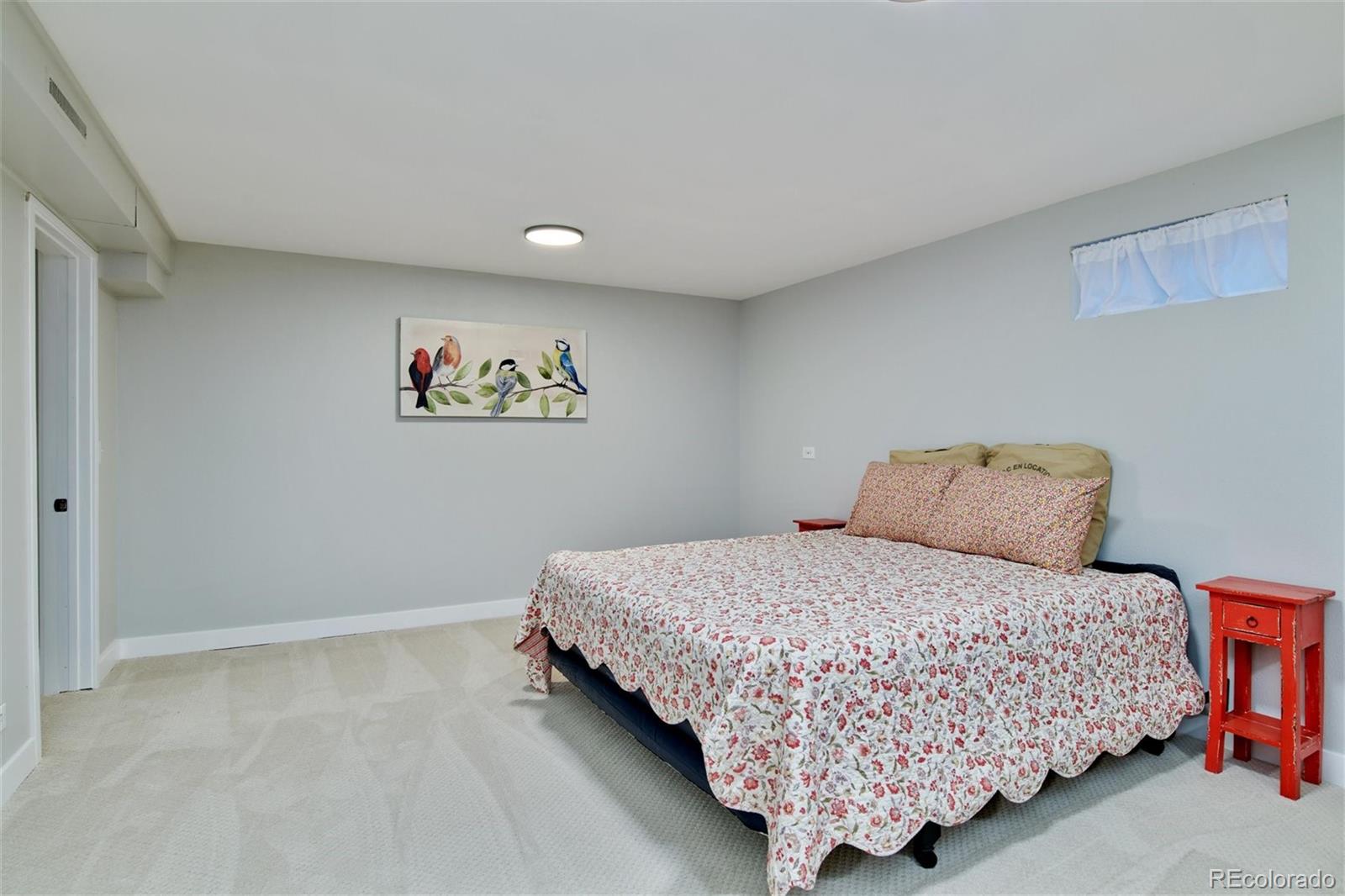 3225 Vance Street Wheat Ridge, CO 80033 - Photo 18 of 29 a bedroom with a bed and painting on the wall