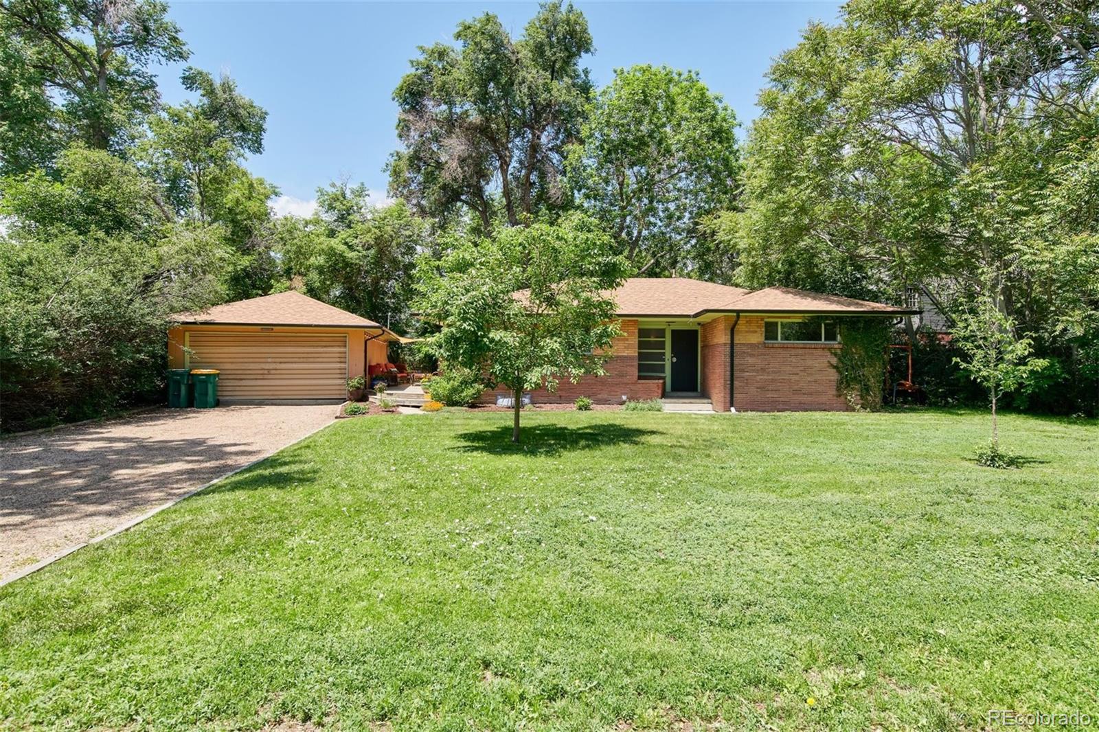 3225 Vance Street Wheat Ridge, CO 80033 - Photo 2 of 29 a front view of a house with a garden