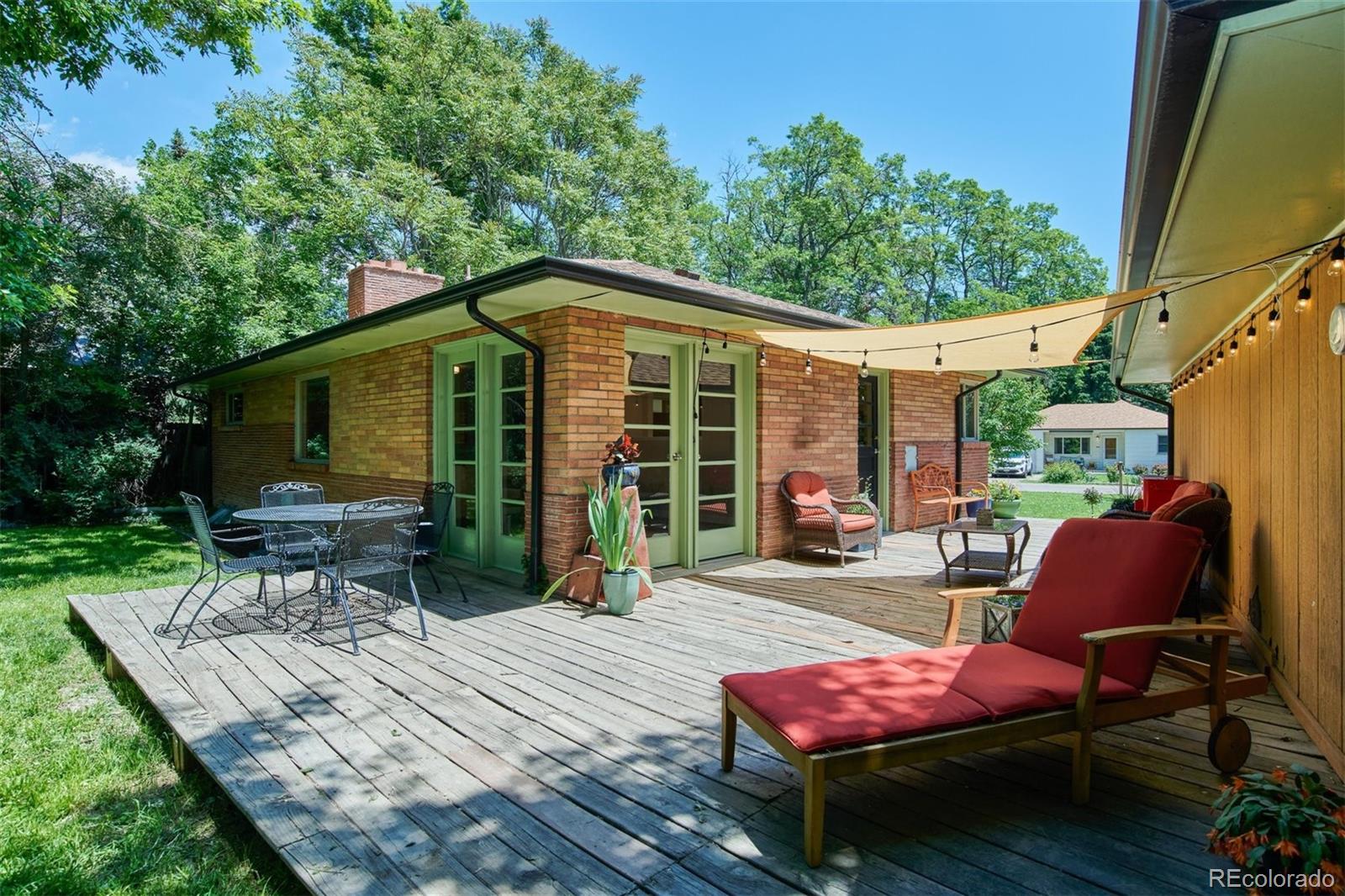3225 Vance Street Wheat Ridge, CO 80033 - Photo 22 of 29 a view of backyard with outdoor seating and green space