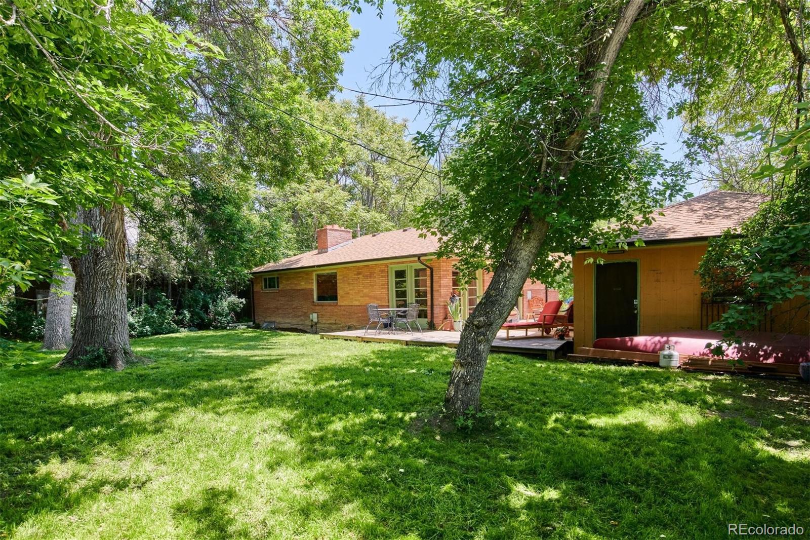 3225 Vance Street Wheat Ridge, CO 80033 - Photo 24 of 29 a view of a backyard with a sitting area and a small yard