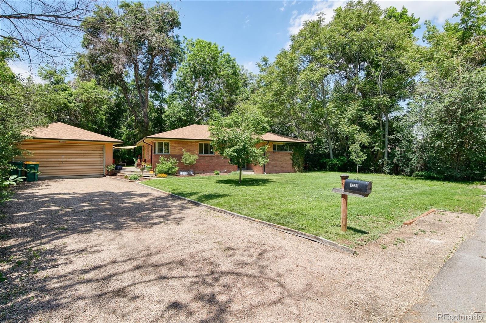 3225 Vance Street Wheat Ridge, CO 80033 - Photo 28 of 29 a house with green field in front of it