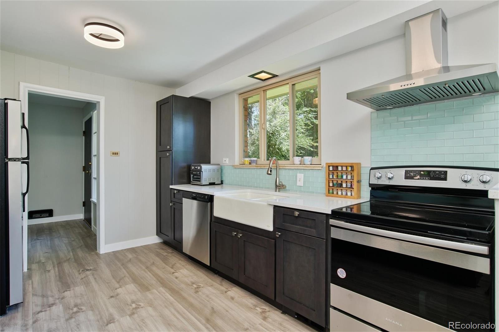 3225 Vance Street Wheat Ridge, CO 80033 - Photo 6 of 29 a kitchen with a stove and a sink