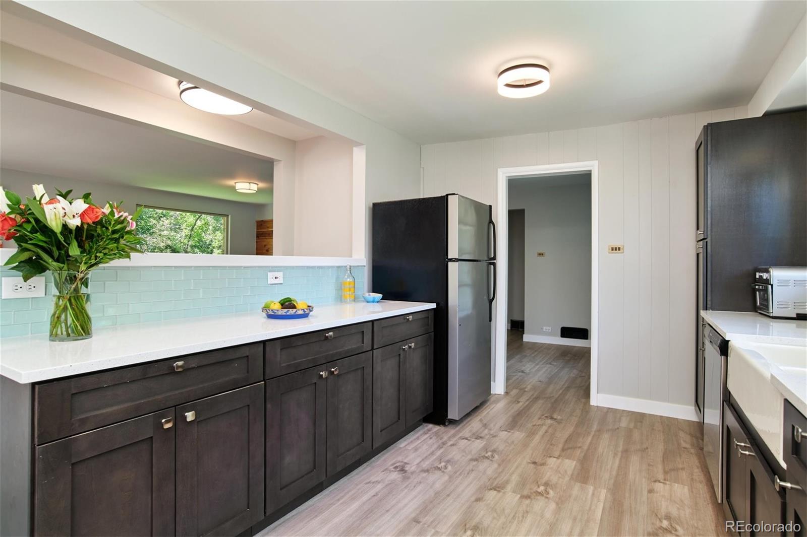 3225 Vance Street Wheat Ridge, CO 80033 - Photo 7 of 29 a kitchen with a refrigerator and a sink
