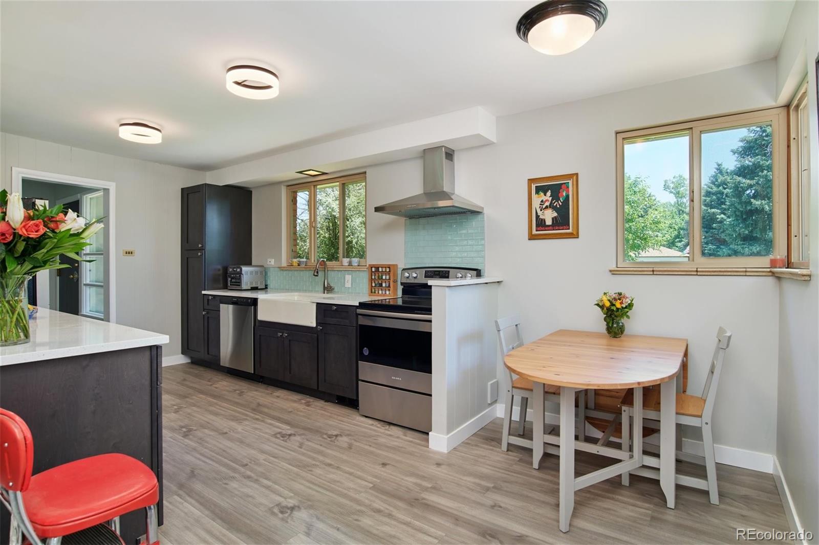 3225 Vance Street Wheat Ridge, CO 80033 - Photo 8 of 29 a kitchen with a table chairs sink and cabinets