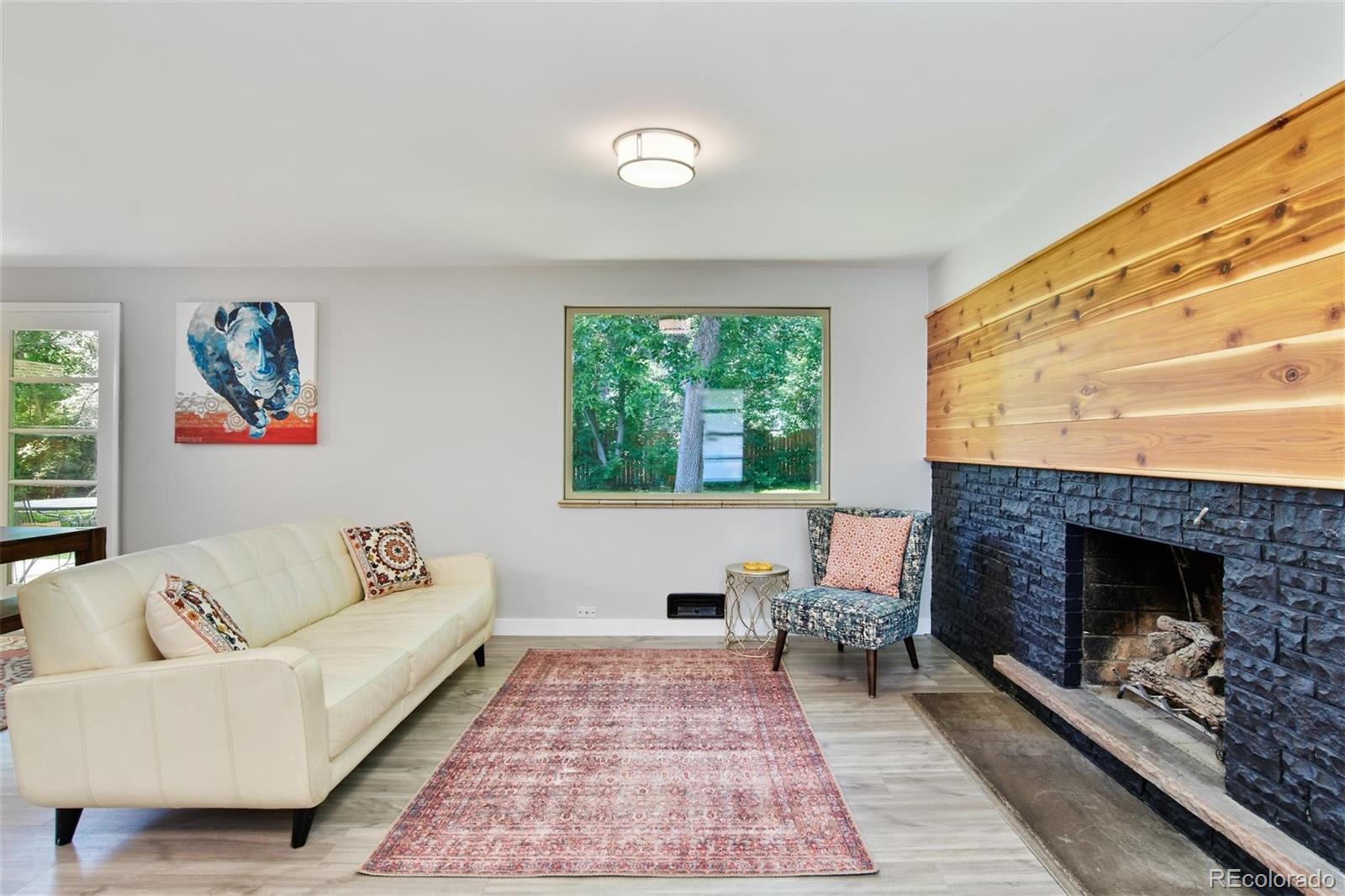 3225 Vance Street Wheat Ridge, CO 80033 - Photo 10 of 29 a living room with furniture and a fireplace