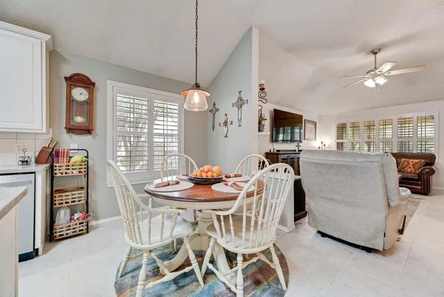 a dining room with furniture and window