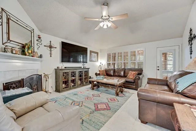 a living room with furniture and a flat screen tv with wooden floor