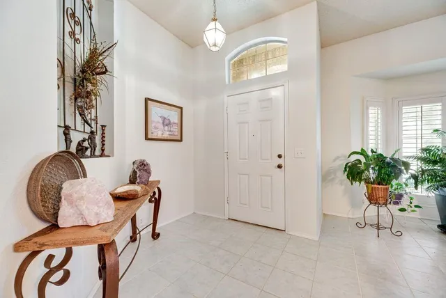 a living room with furniture and large windows
