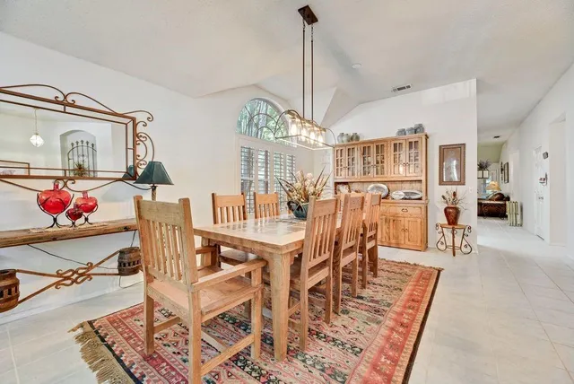 a view of a dining room with furniture a chandelier and wooden floor