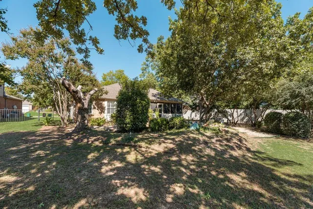 a view of a patio with table and chairs under an umbrella