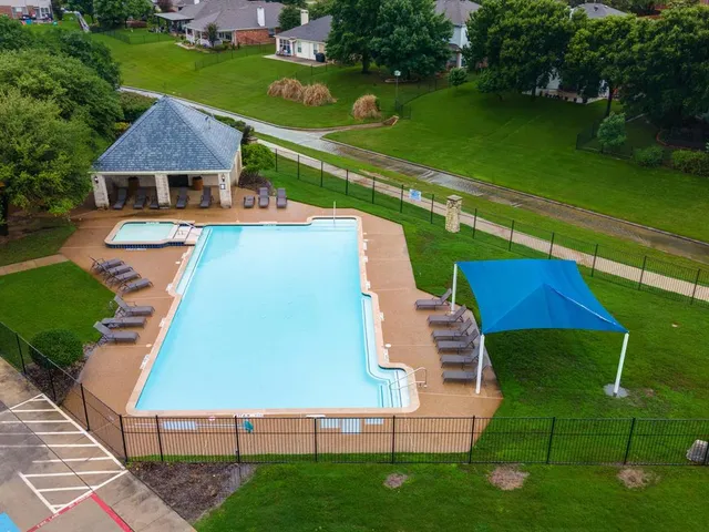 a view of a house with swimming pool and sitting area
