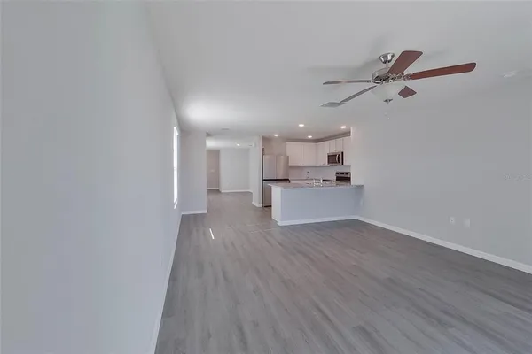 a view of a kitchen with wooden floor and a sink