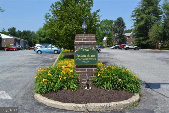 4701 Pennell Road, Unit H3 Aston, PA 19014 - Photo 15 of 18 a front view of a house with a yard and trees