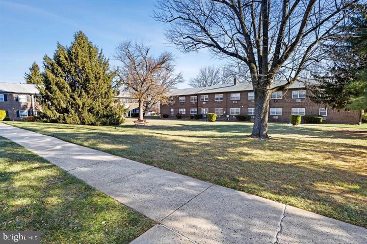 4701 Pennell Road, Unit H3 Aston, PA 19014 - Photo 16 of 18 a view of a house with a big yard and large trees