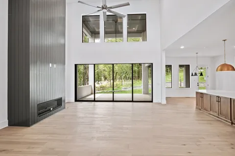 a view of an empty room with a window and walk in closet
