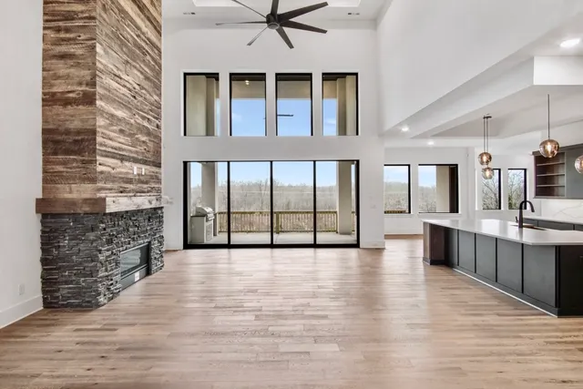 a close view of a faucet a sink and a fireplace in a room