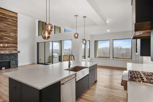 a kitchen with kitchen island a sink appliances and a counter top space