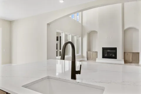 a kitchen with stainless steel appliances kitchen island granite countertop a table and chairs in it