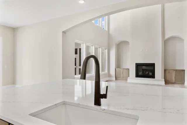 a kitchen with stainless steel appliances kitchen island granite countertop a table and chairs in it