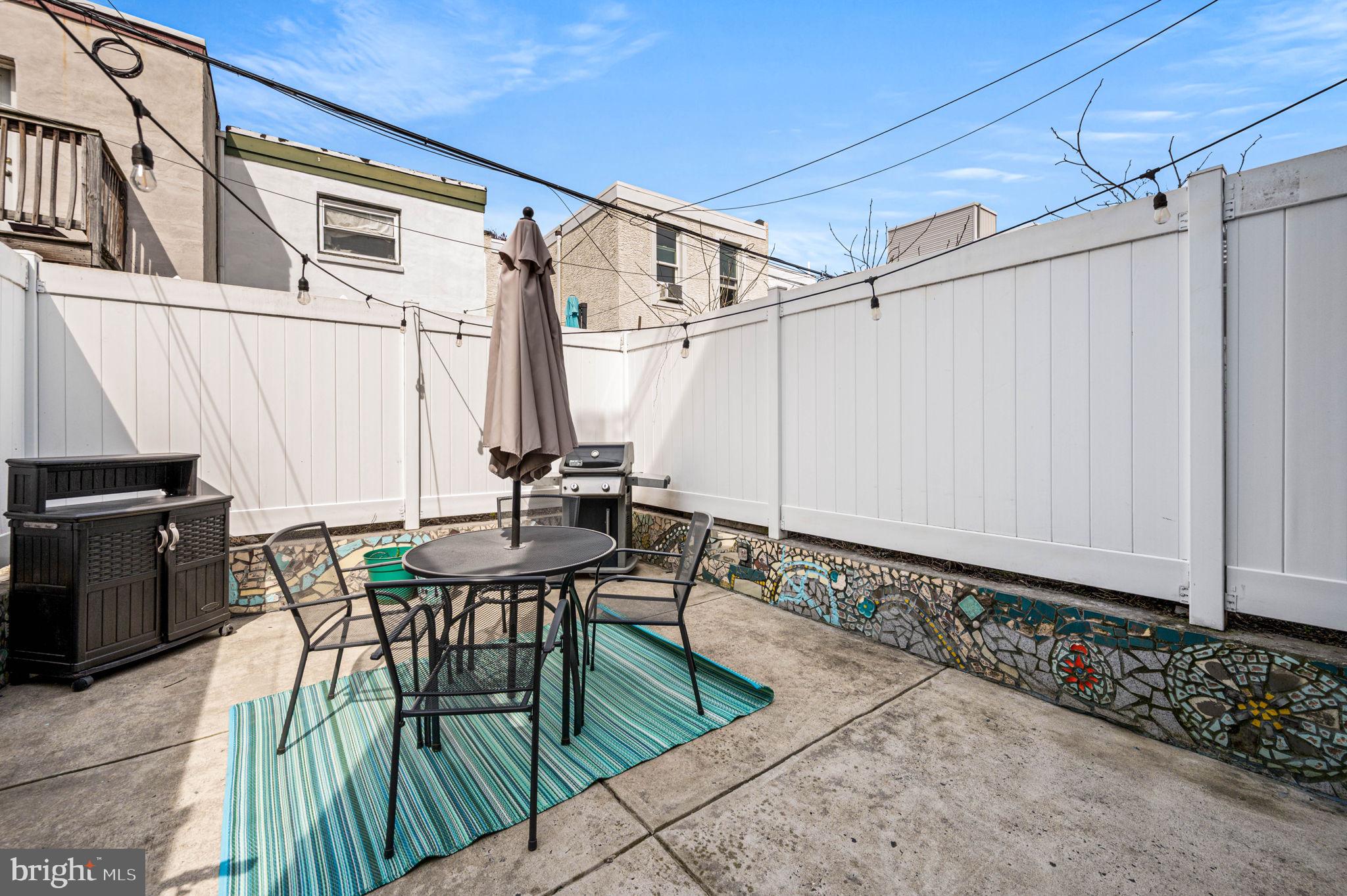 1825 Carpenter Street, Unit A Philadelphia, PA 19146 - Photo 11 of 25 a view of a patio with table and chairs with wooden floor