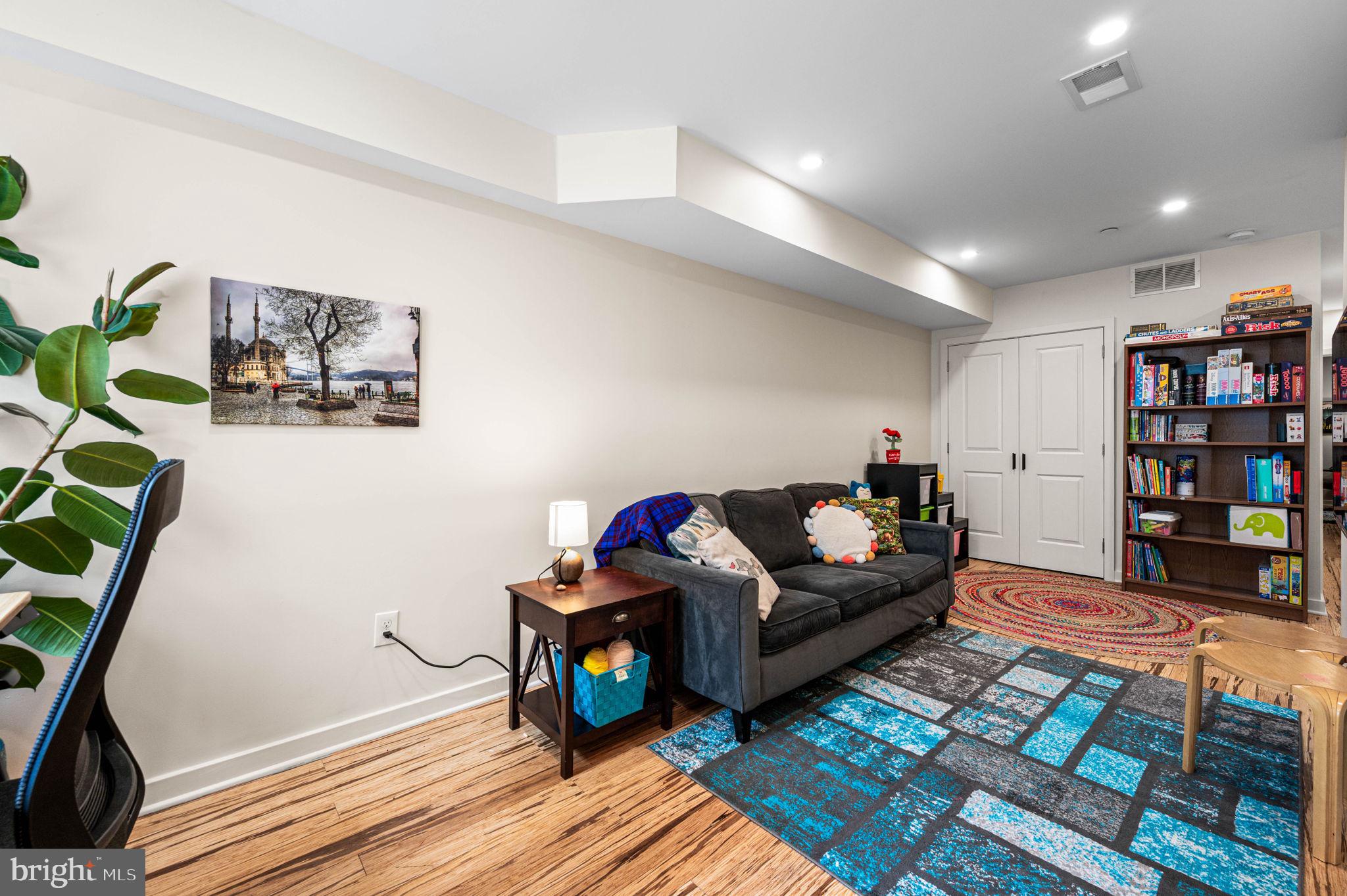 1825 Carpenter Street, Unit A Philadelphia, PA 19146 - Photo 15 of 25 a living room with furniture and a bookshelf with wooden floor