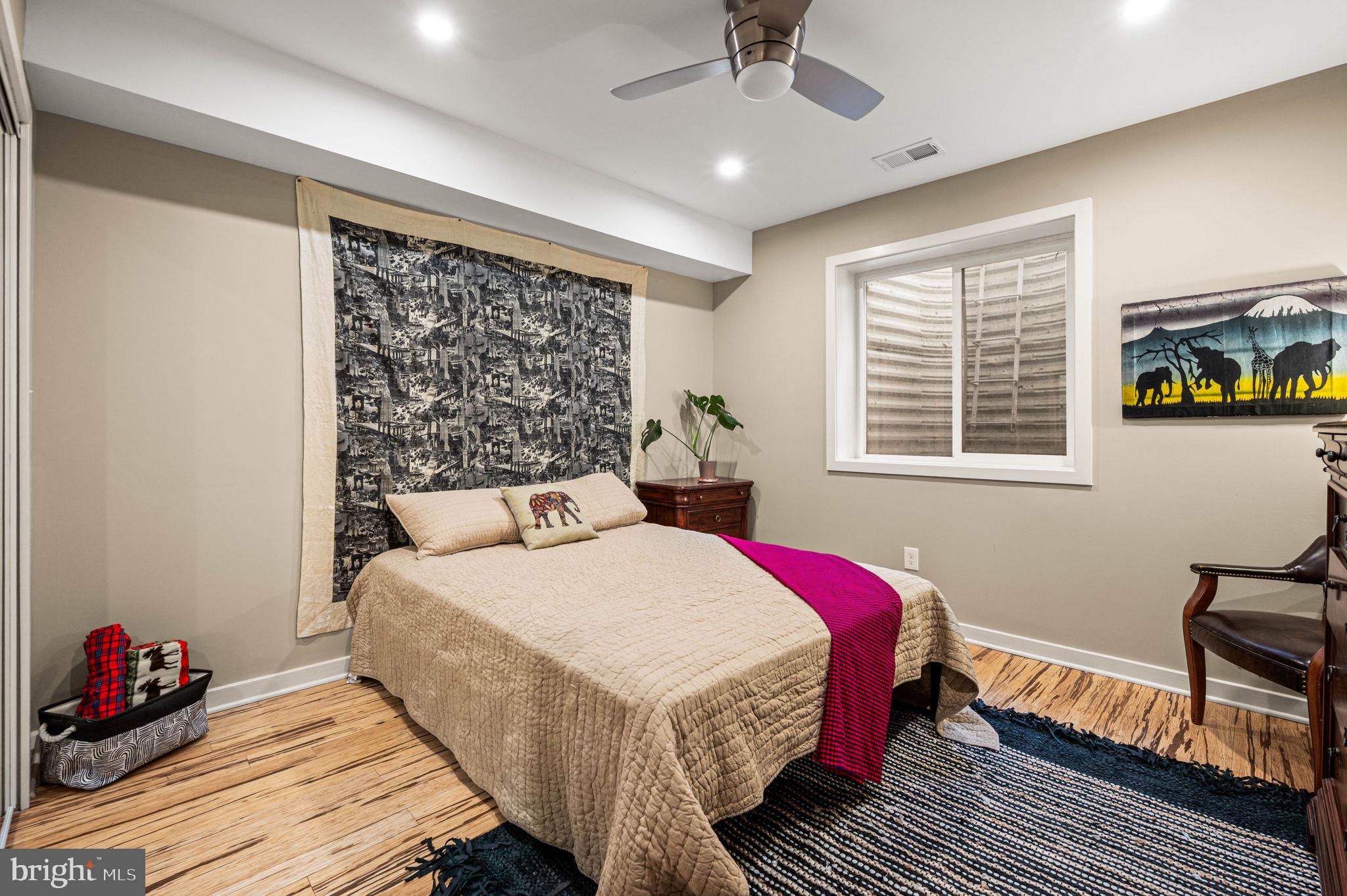 1825 Carpenter Street, Unit A Philadelphia, PA 19146 - Photo 20 of 25 a bedroom with a bed wooden floor and window