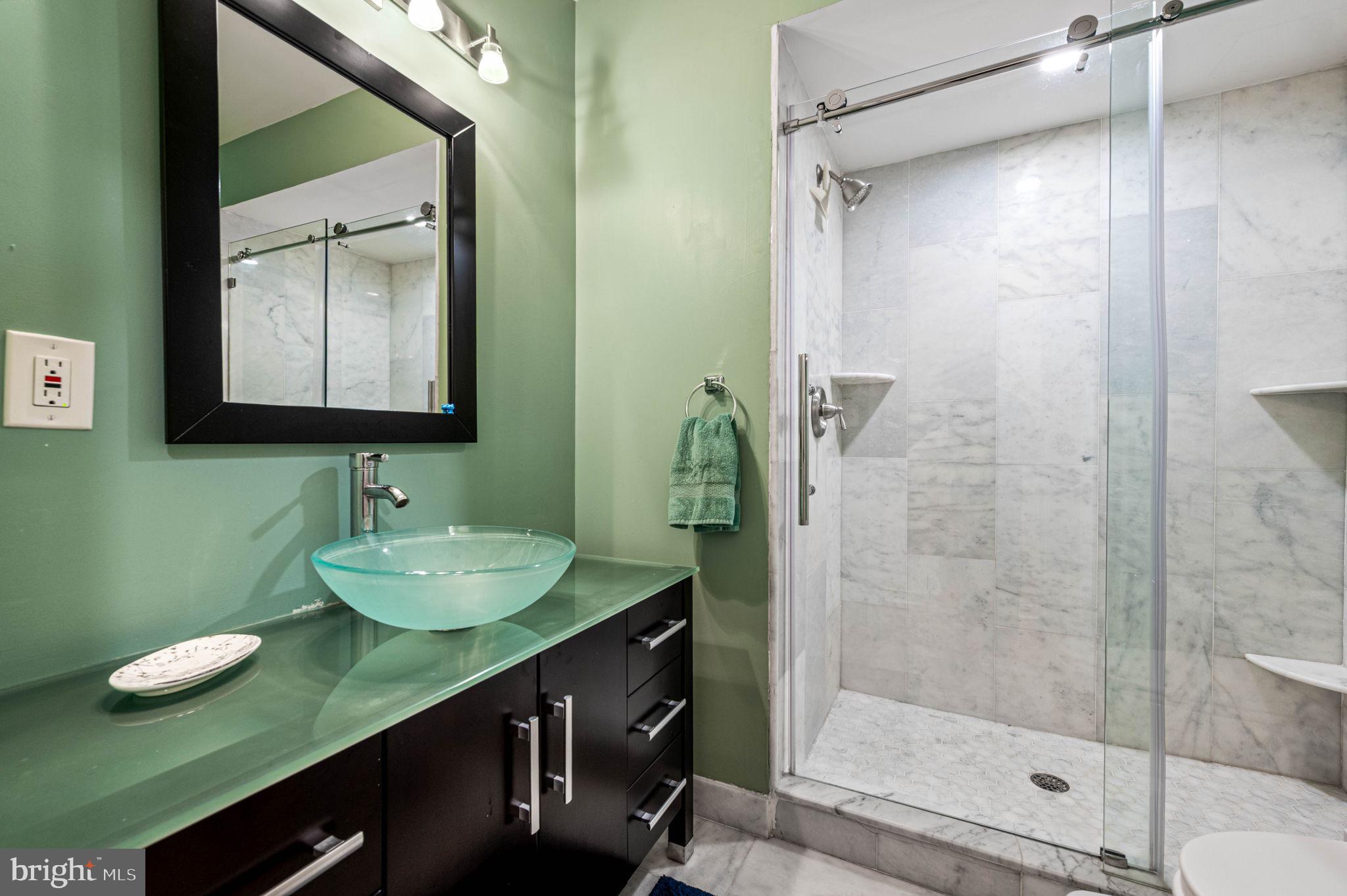 1825 Carpenter Street, Unit A Philadelphia, PA 19146 - Photo 21 of 25 a bathroom with a sink and a mirror