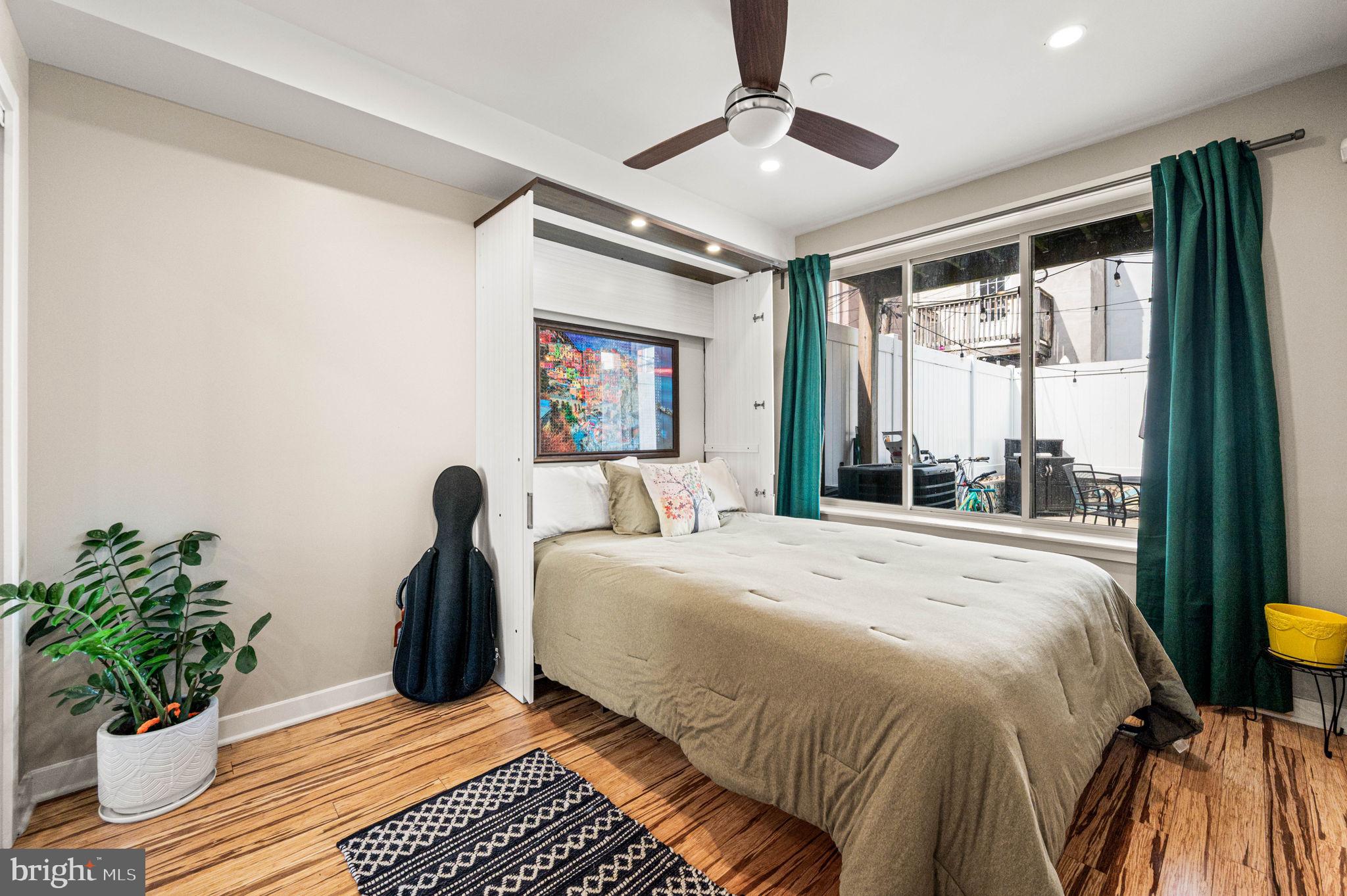 1825 Carpenter Street, Unit A Philadelphia, PA 19146 - Photo 8 of 25 a bedroom with a large bed and a potted plant