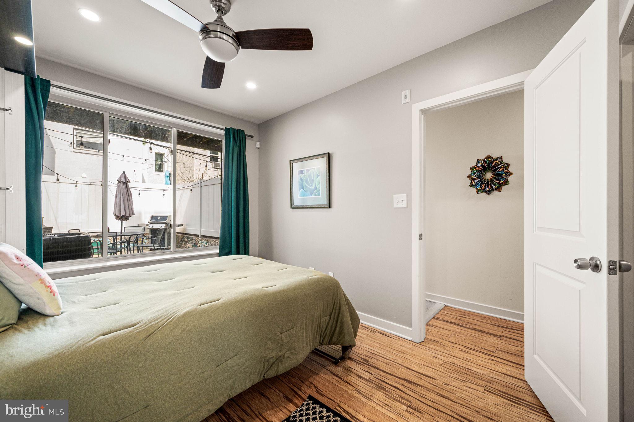 1825 Carpenter Street, Unit A Philadelphia, PA 19146 - Photo 9 of 25 a bedroom with a large bed and a large window