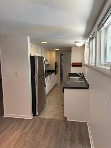 a kitchen with a refrigerator and a stove top oven