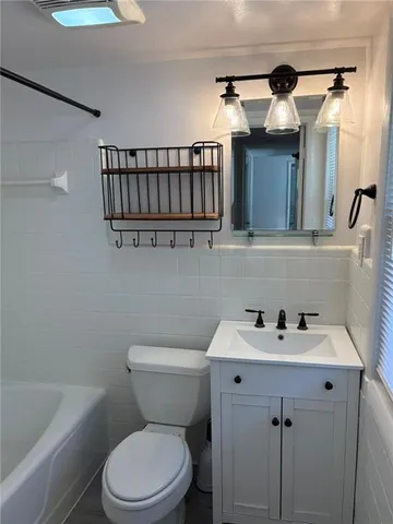 a bathroom with a sink a mirror and a toilet